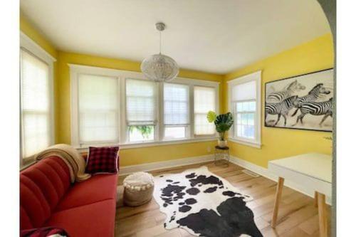 a living room with a red couch and a cow rug at Waterfront house near the Niagara Falls/Canal/Canadian Border in Tonawanda