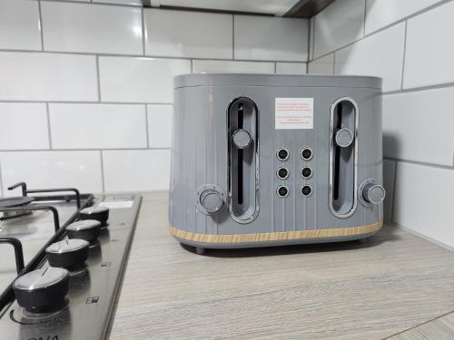 a toaster sitting on a counter next to a stove at Full House on Crab Lane in Hednesford