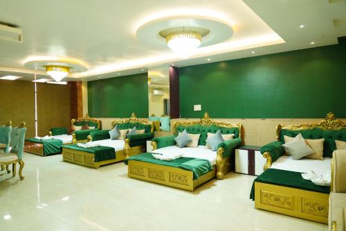 德奧加爾的住宿－MAHARAJA DORMITORY，一间会议室,配有四张床和绿色的墙壁