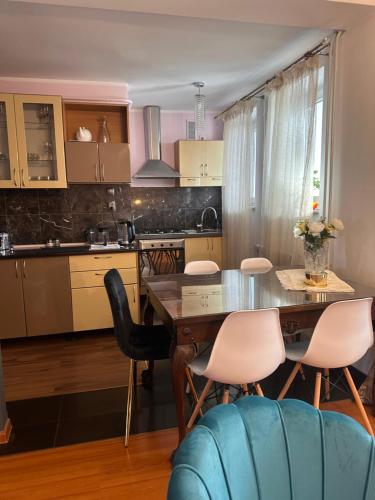 a kitchen with a dining room table and chairs at Apartament Diana - Traugutta Wrocław in Wrocław