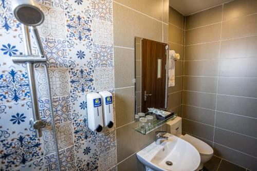 a bathroom with a toilet and a sink at Gia Nguyễn Hotel Dalat in Da Lat