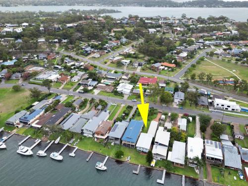 an aerial view of a marina with a yellow arrow at Balmoral Waterfront Escape at Lake Macquarie in Balmoral