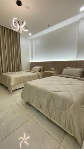 - une chambre avec 2 lits et un ventilateur de plafond dans l'établissement شقق انار السكني, à Khobar