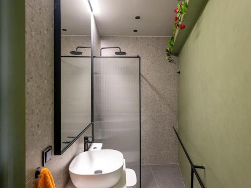 a bathroom with a toilet and a glass shower at Hoppersgr- Amazing apt in the heart of Athens - 3 in Athens
