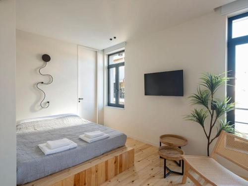 a bedroom with a bed and a tv on a wall at Hoppersgr- Amazing apt in the heart of Athens - 3 in Athens