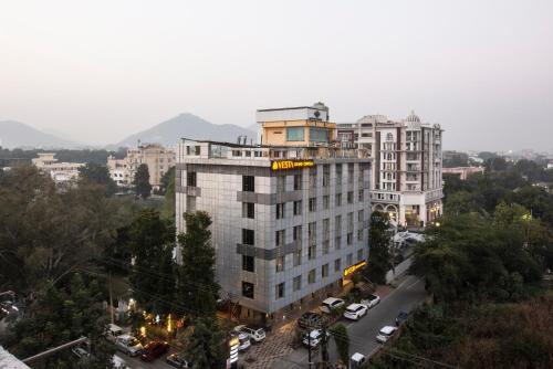 a tall building with a yellow sign on top of it at Vesta Grand Central Udaipur in Udaipur