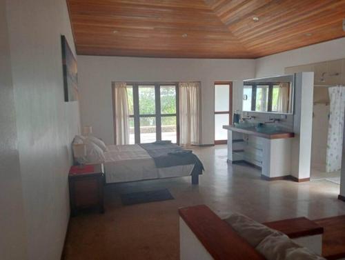 a bedroom with a bed and a desk in a room at 6 Krystal Waters Drive Havannah in Port Vila