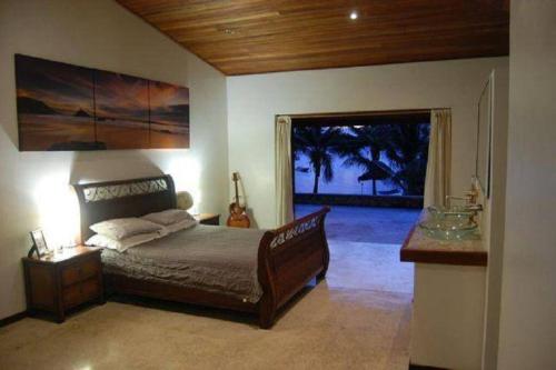 a bedroom with a bed and a large window at 6 Krystal Waters Drive Havannah in Port Vila