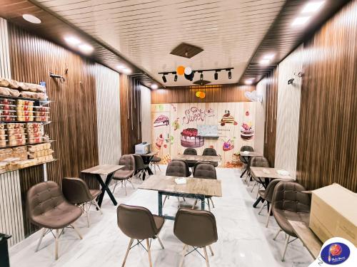 a restaurant with wooden walls and tables and chairs at PLUTO HOMES Dehradun in Dehradun