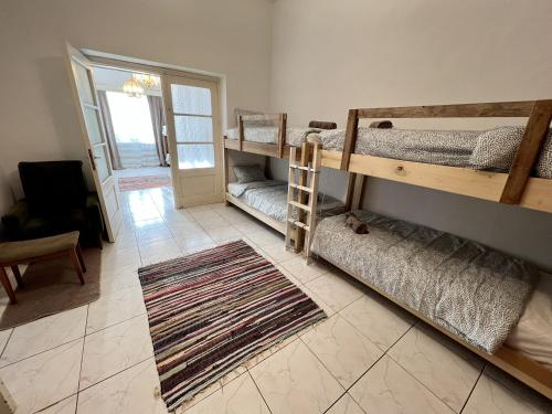 a room with two bunk beds and a rug at Retro Hostel in Limassol