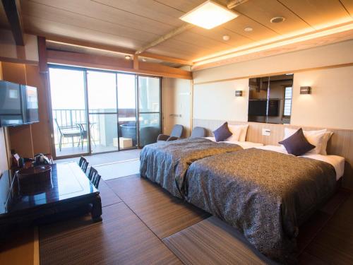 Postel nebo postele na pokoji v ubytování LiVEMAX RESORT Kyotango Sea Front