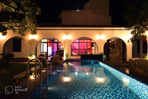 a swimming pool in the middle of a building at night at Tropical Homestay Phu Yen in Tuy Hoa