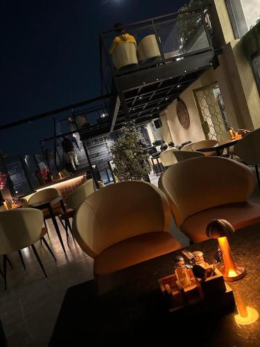 a room with chairs and tables and a table with a christmas tree at The Shanti A Boutique Hotel in Jodhpur