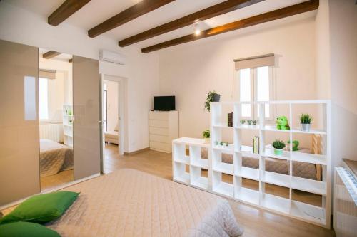 a bedroom with white shelves and a bed in a room at NonSoloValle in Chiaravalle