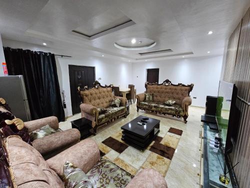 a living room with couches and a table at Serene Oasis in Ikorodu