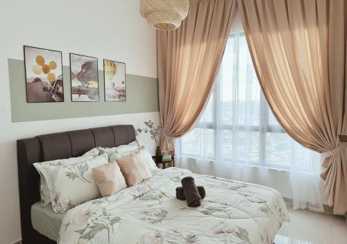 a teddy bear sitting on a bed in a bedroom at Tranquil Suite, MKH Boulevard 2 in Kajang