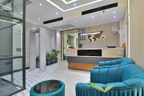 an office lobby with blue chairs and a reception desk at Hotel Uptown - Near New Delhi Railway Station - Paharganj in New Delhi