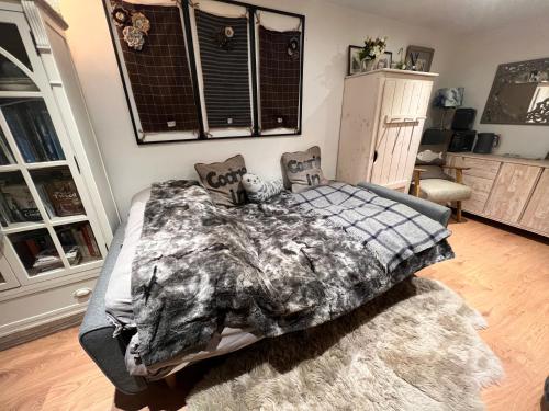 a bedroom with a bed with a wolf blanket at The Coorie Inn @ Portobello, Edinburgh’s Seaside. in Edinburgh