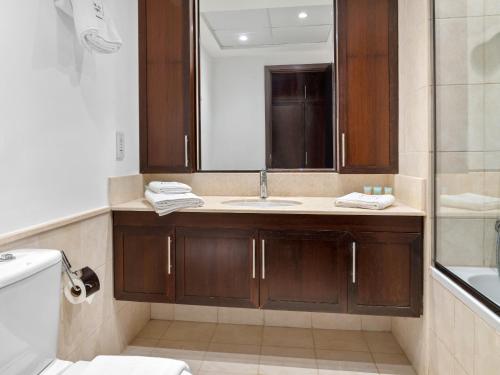 a bathroom with a sink and a mirror at Lush Interior Brand New 1BDR-Heart of Downtown in Dubai