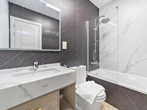 a bathroom with a sink and a toilet and a shower at Brand New 1BDR Dubai Marina -Close to Metro in Dubai