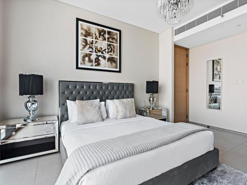 a bedroom with a large bed and two night stands at Contemporary Designed 1BDR - Address Beach JBR in Dubai