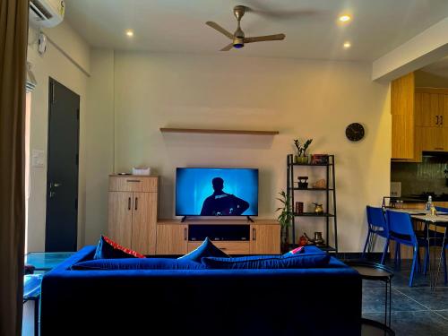 a living room with a couch and a tv at Green Horizon, Luxury & Nature at Kothamangalam in Kotamangalam