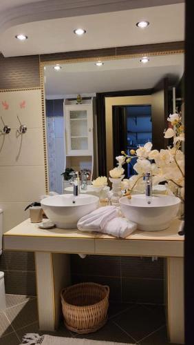 a bathroom with two sinks and a large mirror at Mery's Countryside House in Agios Mamas