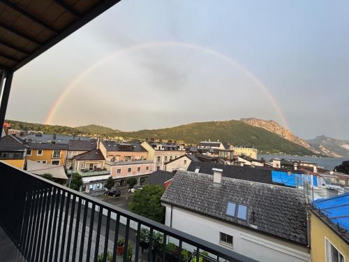a rainbow over a town with houses and a city at CityLake G23 Apartments in Gmunden