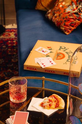 a table with a slice of pizza and a box at Eden Hotel Amsterdam in Amsterdam
