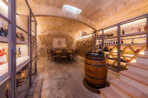 a wine cellar with a table and a large barrel at Yartan Boutique Hotel - Adults Only in Artá