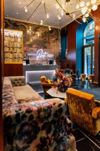 a lobby with a couch and chairs and a table at Grand Poet Hotel and SPA by Semarah in Riga