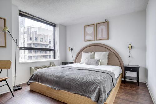 a bedroom with a large bed and a window at Streeterville Studio w Gym Pool nr Navy Pier CHI-450 in Chicago