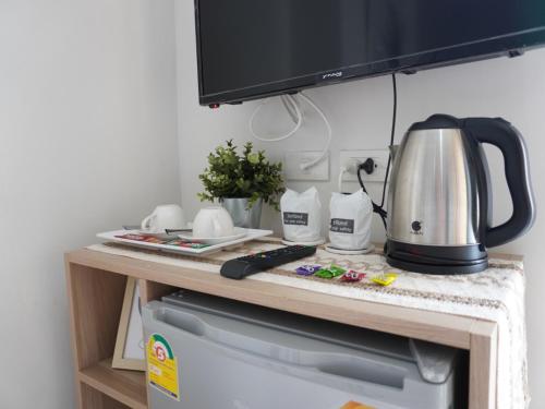 a kitchen counter with a tea kettle on it at ATC Residence in Bang Su