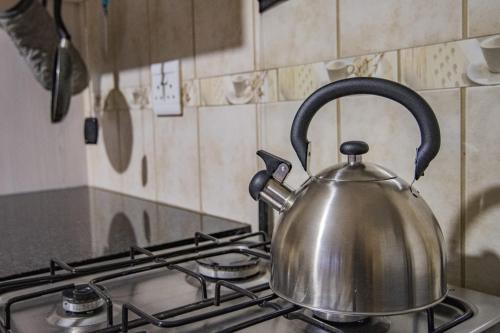 a tea kettle sitting on top of a stove at The South Post @ Kruger in Marloth Park
