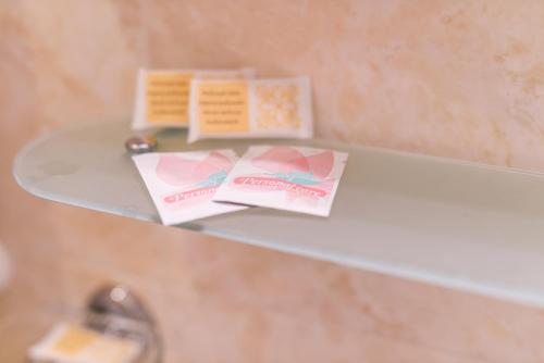 a glass shelf with two cards on top of it at Casa San Giuseppe in Rome