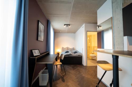 1 dormitorio con cama y escritorio en NEOApartments, en Berlín
