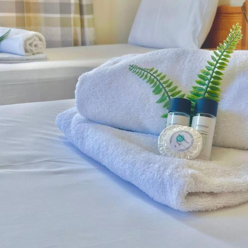 a pile of towels and moisturizers on a bed at Merika Complex 1 in Pervolia