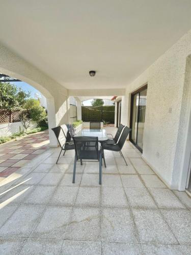 a patio with a table and chairs on a patio at Merika Complex 1 in Pervolia