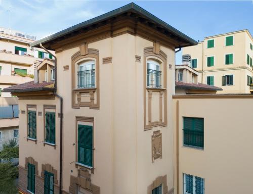 a building with green shuttered windows and buildings at Casa San Giuseppe in Rome