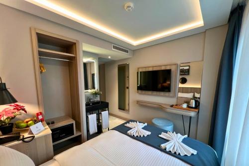 a hotel room with a bed and a television at Woxx Hotel in Istanbul