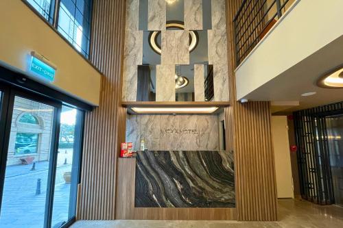 a lobby with a large painting on the wall at Woxx Hotel in Istanbul