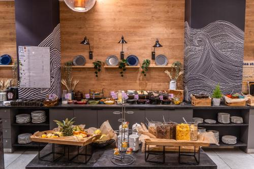 a kitchen with two tables with food on it at Novotel Szczecin Centrum in Szczecin