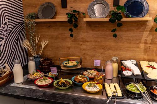 a buffet line with many different types of food at Novotel Szczecin Centrum in Szczecin