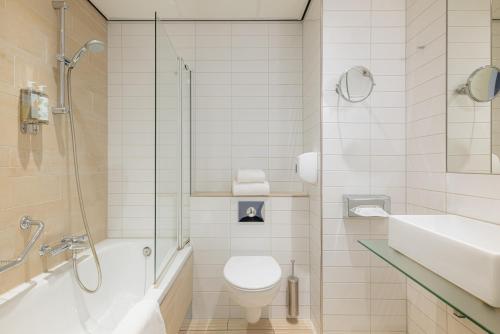 a bathroom with a toilet and a shower and a sink at Eden Hotel Amsterdam in Amsterdam