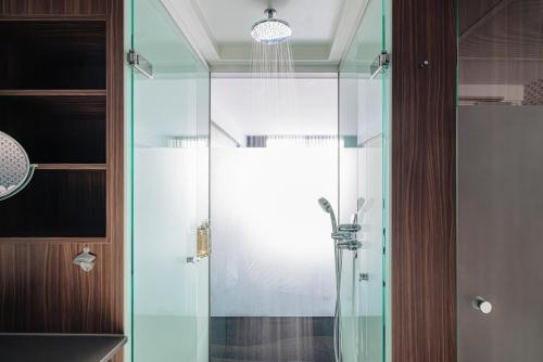 a shower with a glass door in a bathroom at Eden Hotel Amsterdam in Amsterdam