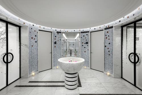 a bathroom with a sink in a room with windows at Dinamo Hotel Baku in Baku