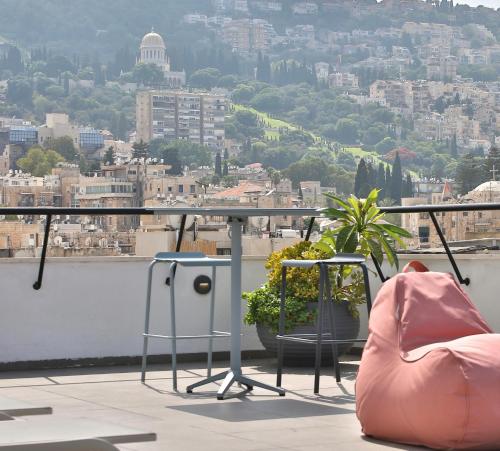 a balcony with a table and chairs and a city at ROOFTOP 42 - Penthouse in Haifa