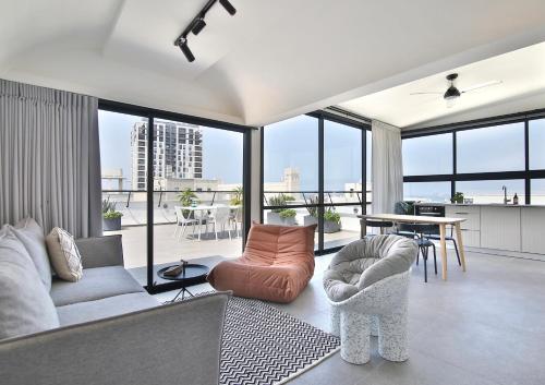 a living room with a couch and a table at ROOFTOP 42 - Penthouse in Haifa