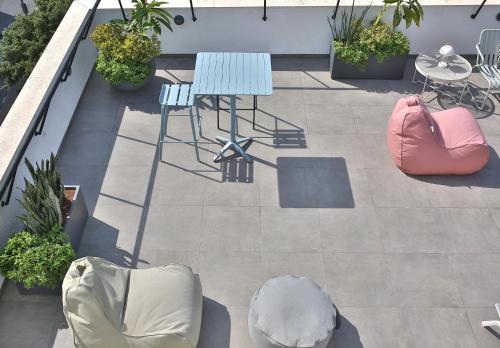 a patio with a table and chairs on a balcony at ROOFTOP 42 - Penthouse in Haifa