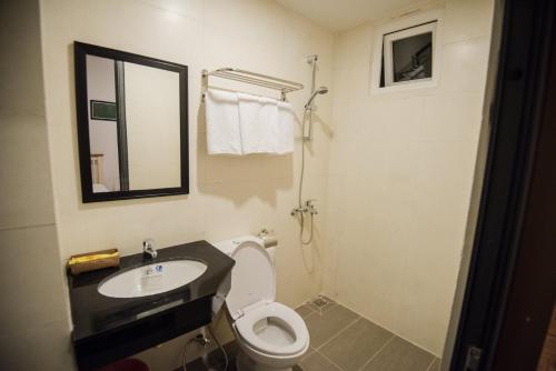 a bathroom with a sink and a toilet and a mirror at 1991 Boutique Hotel in Phan Thiet